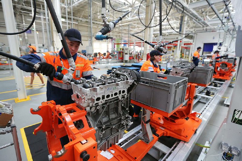 Workers assemble Ford Duratec engines Thursday at the new Ford Sollers plant in Elabuga, Russia. 