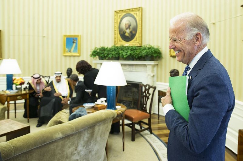 Vice President Joe Biden stands in the Oval Office as President Barack Obama talks Friday with King Salman of Saudi Arabia.
