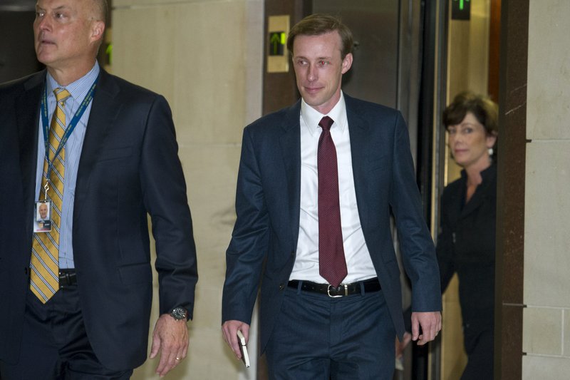 Former Hillary Clinton aide, during her tenure as Secretary of State, Jake Sullivan, center, arrives to be interviewed before a House panel on the Benghazi investigation on Capitol Hill in Washington, Friday, Sept. 4, 2015. 