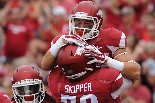 Arkansas' Drew Morgan (top) celebrates with Dan Skipper against University of Texas at El Paso's Saturday, Sept. 5, 2015, during the first quarter of play in Razorback Stadium in Fayetteville.