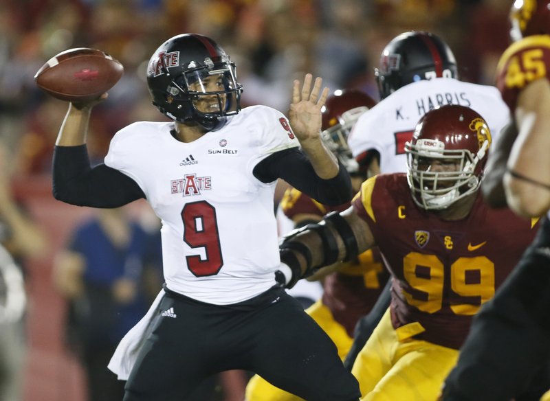 Arkansas State quarterback Fredi Knighten throws under pressure against Southern California during the first half of an NCAA college football game, Saturday, Sept. 5, 2015, in Los Angeles.
