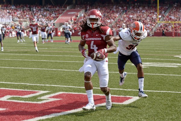 Arkansas wide receiver Keon Hatcher scores a touchdown under defense from Kalon Beverly of UTEP on Saturday, Sept. 5, 2015, at Razorback Stadium in Fayetteville. 