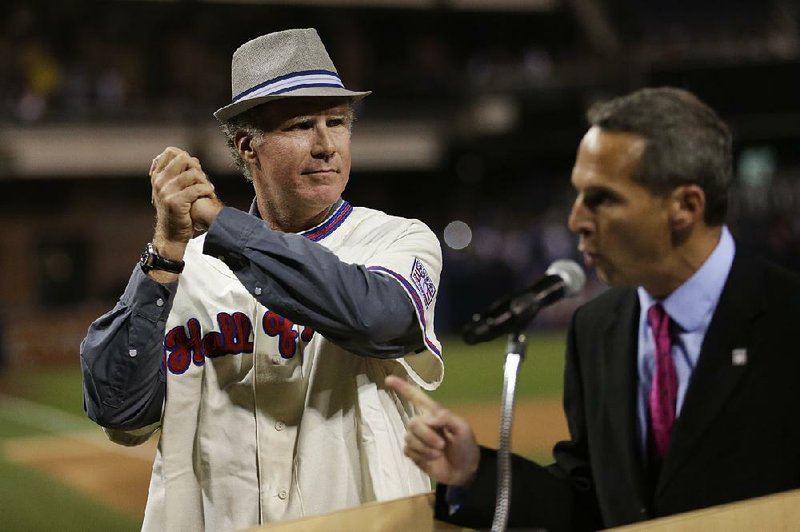 Actor Will Ferrell, left, plays to the crowd during his Hall of Fame presentation Saturday at Petco Park in San Diego before a screening of the new HBO documentary, Ferrell Takes the Field. Jeff Idelson, President of the National Baseball Hall of Fame and Museum is shown at right.