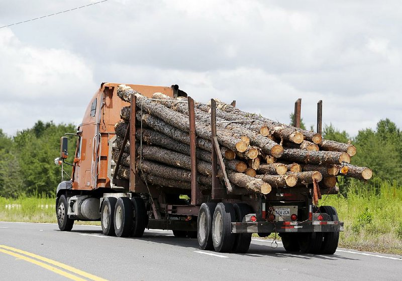 A truckload of logs heads to the Klausner lumber mill in Live Oak, Fla., in late July. 