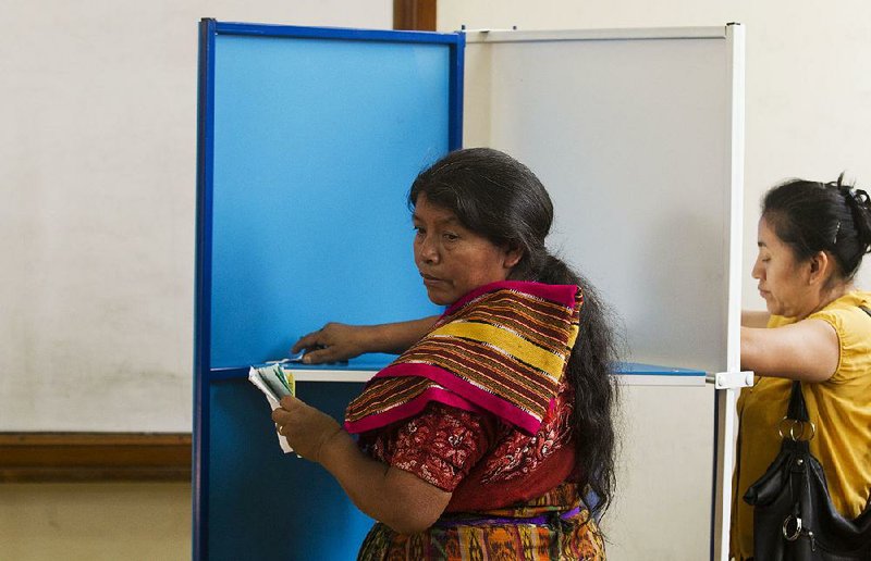 Women cast their votes Sunday at a polling station in Mixco, Guatemala.