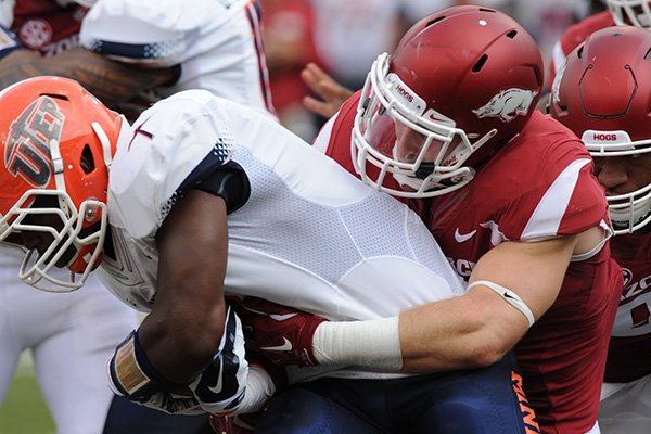 Arkansas' Brooks Ellis (right) tackles University of Texas at El Paso's Treyvon Hughes Saturday, Sept. 5, 2015, during the first quarter of play in Razorback Stadium in Fayetteville.