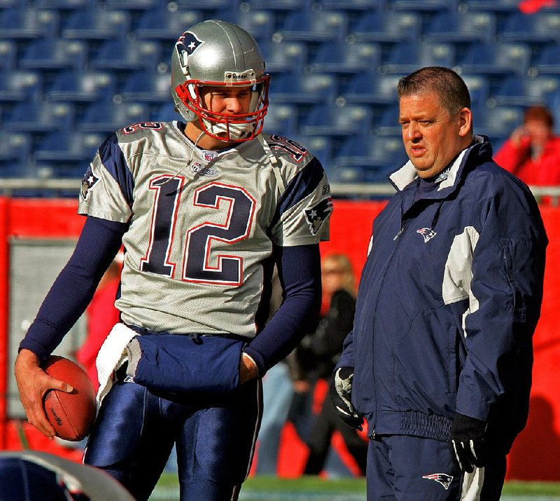 Charlie Weis (right), shown with New England Patriots quarterback Tom Brady in 2004, was the Patriots’ offensive coordinator in 2000-2004, helping lead them to three Super Bowls. 