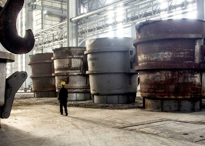 A worker walks through an idle section of a steel plant in Danyang in eastern China’s Jiangsu province in this file photo. The European Union Chamber of Commerce in China has urged China to speed up market-opening changes. 
