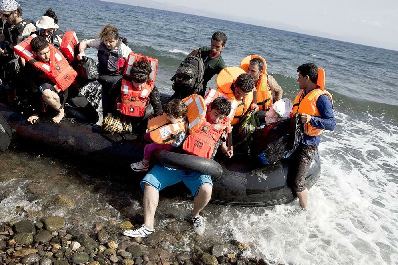 Migrants arrive on the Greek island of Lesbos on Tuesday aboard a dinghy that crossed from Turkey to Greece.