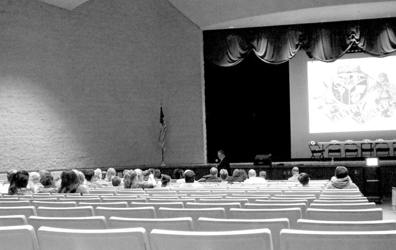 Photo by Randy Moll A modest crowd gathered in the Gentry High School auditorium on Sept. 1 to learn about a district plan to apply for a conversion charter school within the district. Randy Barrett, school district superintendent, is addressing those in attendance.