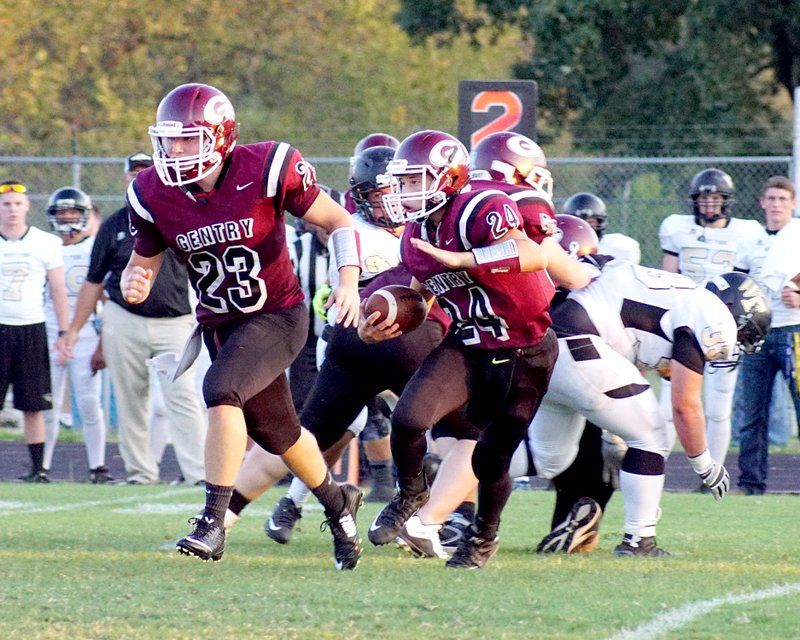 Photo by Randy Moll Cole Cripps, Gentry junior, behind Tanner Christie, a sophomore, runs the ball around the left side to pick up yards against the visiting West Fork Tigers on Friday.
