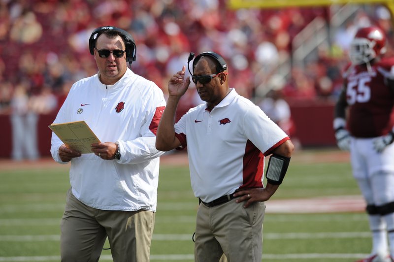 Arkansas coach Bret Bielema speaks with receivers coach Michael Smith against University of Texas at El Paso's Saturday, Sept. 5, 2015, during the third quarter of play in Razorback Stadium in Fayetteville. 