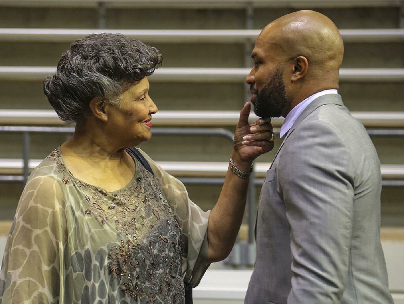 Former UALR guard Derek Fisher is greeted by his mother, Annette, who complimented his beard, prior to Wednesday’s news conference for the school’s upcoming fundraiser.