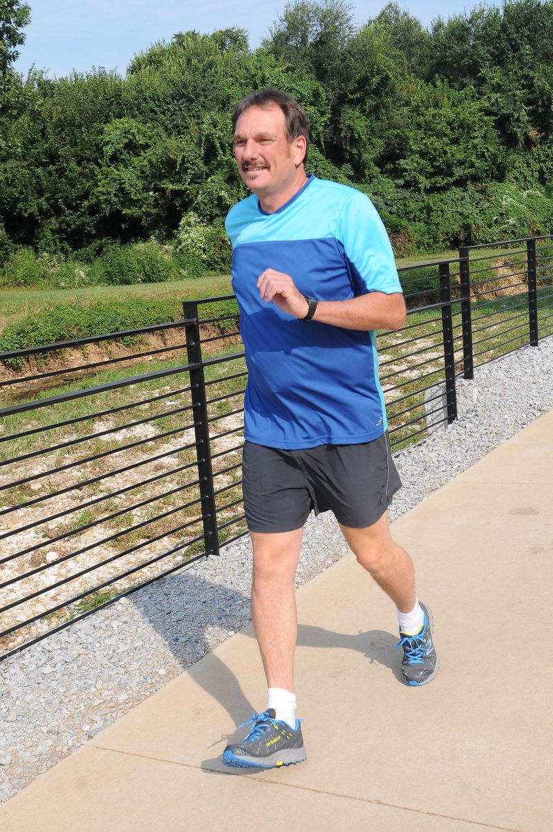 Ross Hinshaw of Springdale ran and walked and all 37 miles of the Razorback Greenway in three consecutive days to celebrate his 60th birthday. He’s seen here in August near downtown Spring dale.