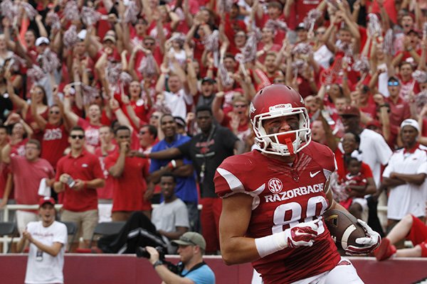 In this Sept. 5, 2015, photo, Arkansas fans cheer as Drew Morgan scores a touchdown for the Razorbacks during the NCAA college football game against UTEP at Donald W. Reynolds Razorback Stadium in Fayetteville, Ark. The Razorbacks beat the Miners, 48-13. (AP Photo/Samantha Baker)