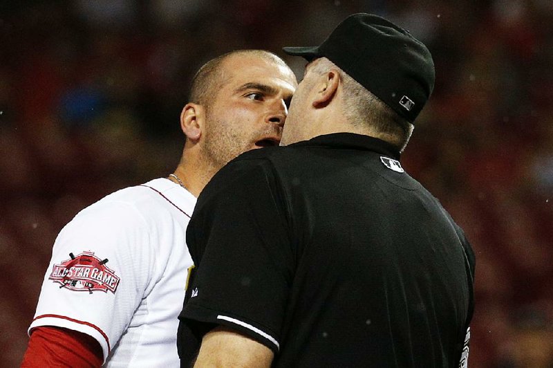 Cincinnati Reds' Joey Votto, left, argues with umpire Bill Welke after being thrown out of the game for arguing balls and strikes in the eighth inning of a baseball game against the Pittsburgh Pirates, Wednesday, Sept. 9, 2015, in Cincinnati. 