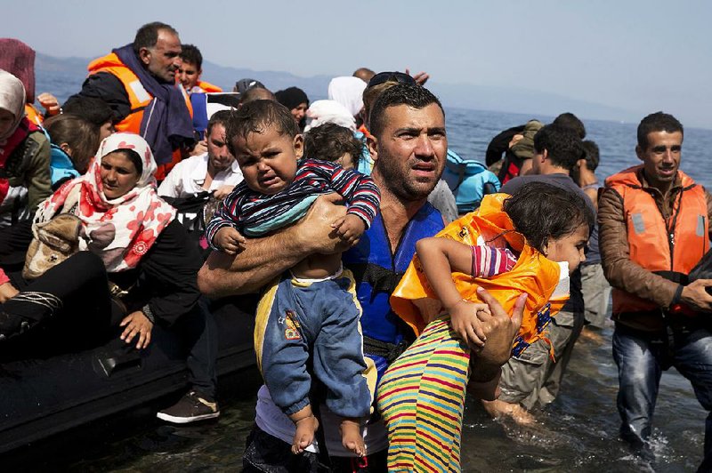 Syrian refugees arrive aboard a dinghy Thursday after crossing from Turkey to the Greek island of Lesbos. 
