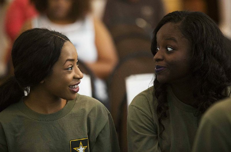 Deangela Horton, 17, (left) and Dominique Darrough, 17, both training for the Army, chat before Thursday’s ceremony at the MacArthur Museum of Military History in Little Rock.