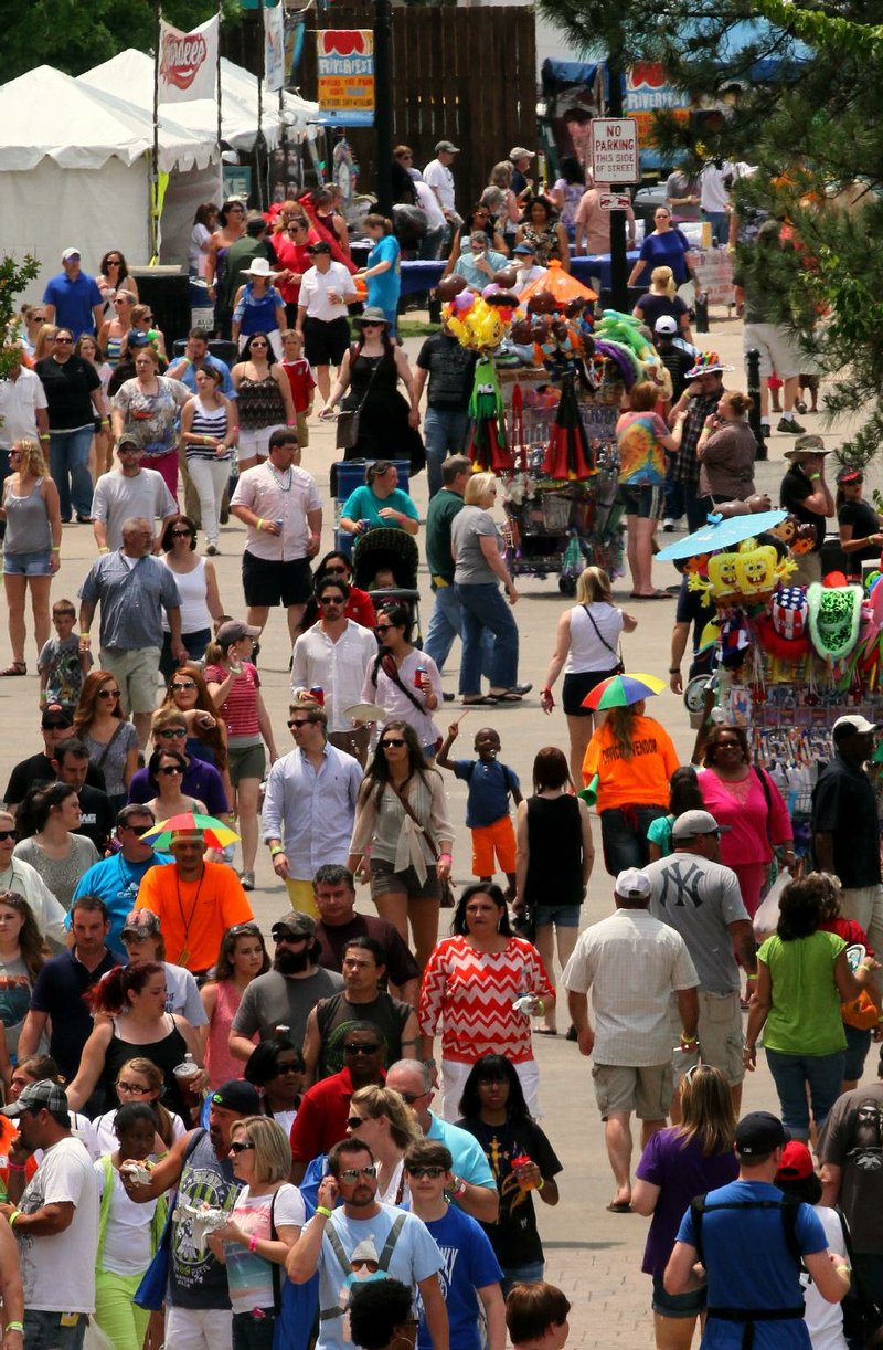 FILE — A crowd walks through Riverfest in 2013.