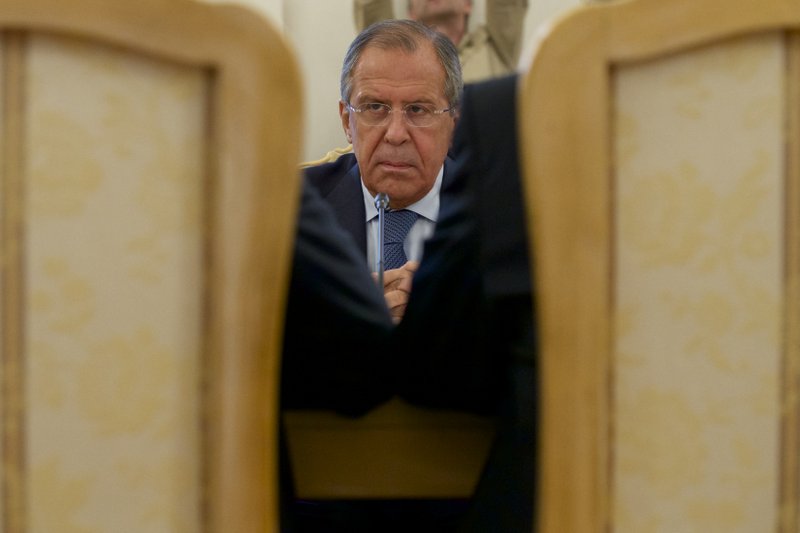 Russian Foreign Minister Sergey Lavrov listens his counterparts Ibrahim Gandour, from Sudan, left, and Benjamin Barnaba, from South Sudan, right, during their trilateral meeting in Moscow, Russia, on Thursday, Sept. 10, 2015.