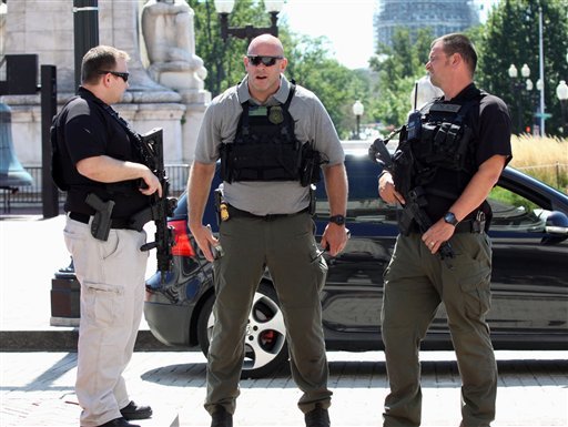 Police officers stand outside Union Station in Washington on Friday, Sept. 11, 2015, after a security guard shot a man who stabbed a woman inside, District of Columbia police said.