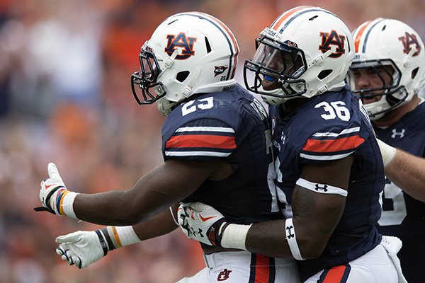 Auburn Tigers running back Peyton Barber (25) celebrates with full back Kamryn Pettway (36) after scoring the winning touchdown during overtime of an NCAA college football game against Jacksonville State, Saturday, Sept. 12, 2015, in at Jordan-Hare Stadium in Auburn, Ala. (Albert Cesare/The Montgomery Advertiser via AP)