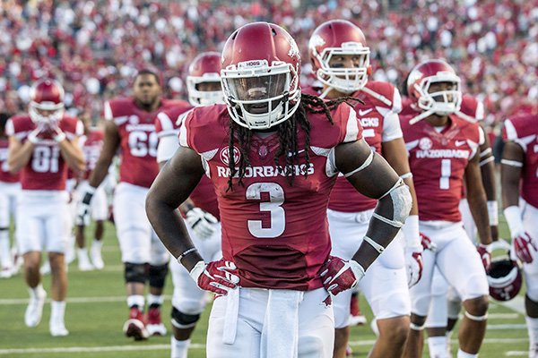 Arkansas junior running back Alex Collins and other players leave the field on Saturday, Sept. 12, 2015, following the Razorbacks' 16-12 loss to Toledo at War Memorial Stadium in Little Rock.