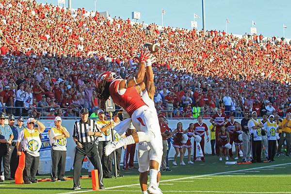 Arkansas receiver Keon Hatcher goes up for a pass during the fourth quarter of a game against Toledo on Saturday, Sept. 12, 2015, at War Memorial Stadium in Little Rock. 