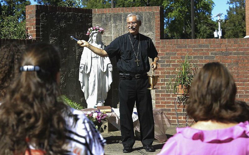 Bishop Anthony Taylor sprinkles holy water on people Saturday in Little Rock, blessing those planning to travel to Washington, D.C., and Philadelphia to see Pope Francis during his coming trip to the U.S.