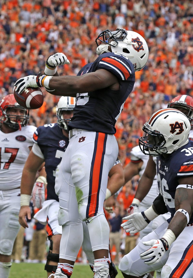 Auburn running back Peyton Barber celebrates after scoring the game-winning touchdown in overtime as the No. 6 Tigers beat Jacksonville State 27-20 on Saturday. Barber finished with 125 yards rushing for Auburn, which travels to No. 14 LSU next week. 