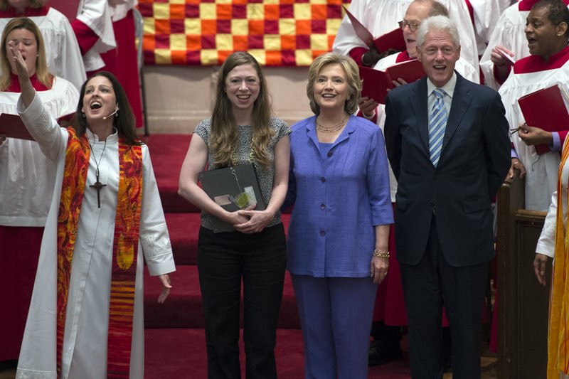 Democratic presidential candidate Hillary Rodham Clinton, center right, her daughter, Chelsea, second from left, and former President Bill Clinton attend the Foundry United Methodist Church for their Bicentennial Homecoming Celebration, in Washington, Sunday, Sept. 13, 2015. During Bill Clinton's presidency, the Clintons worshipped and participated regularly at Foundry. Rev. Ginger Gaines-Cirelli stands at left. 