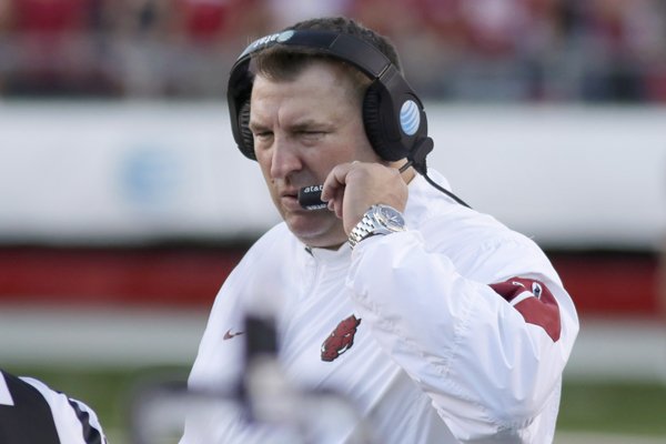 Arkansas coach Bret Bielema talks into his headset during the fourth quarter of an NCAA college football game against Toledo in Little Rock, Ark., Saturday, Sept. 12, 2015. Toledo defeated Arkansas 16-12. (AP Photo/Danny Johnston)