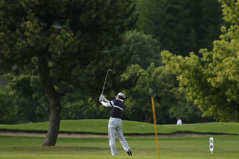 A golfer plays at the Higashi Abiko Country Club, owned and operated by Asahi Corp., in Abiko,
Chiba Prefecture, Japan in June. 