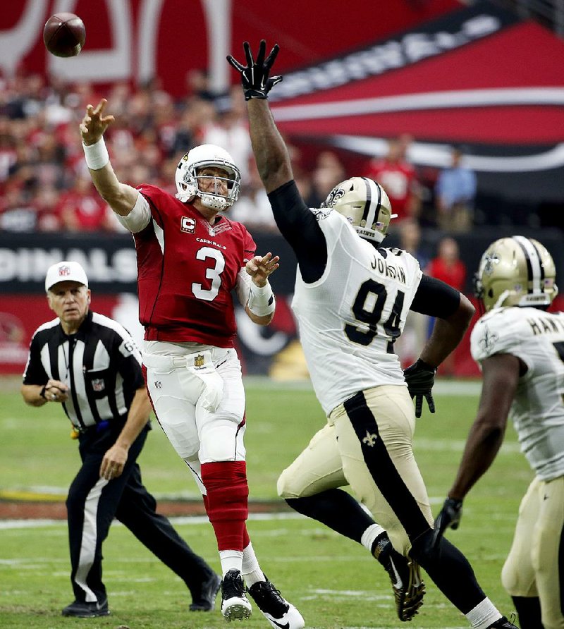 Arizona Cardinals quarterback Carson Palmer (3) throws under pressure from New Orleans Saints defensive end Cameron Jordan (94) during the first half of an NFL football game, Sunday, Sept. 13, 2015, in Glendale, Ariz.