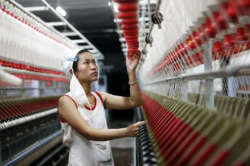 An employee works in a textile factory in Huaibei in central China’s Anhui province in August.