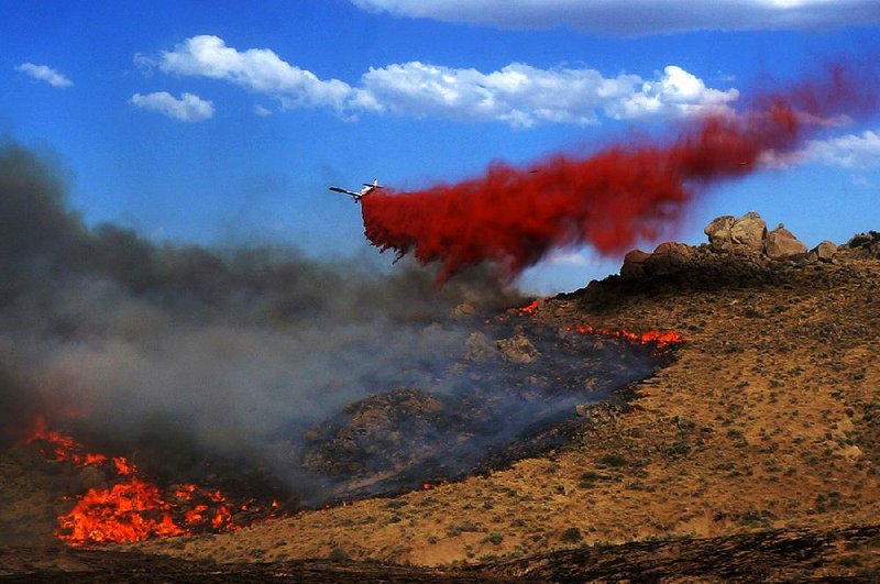 This photo taken in August by Utah firefighter Eli Peterson shows a firefighting plane dropping retardant over the Soda Fire in Owyhee County, Idaho.