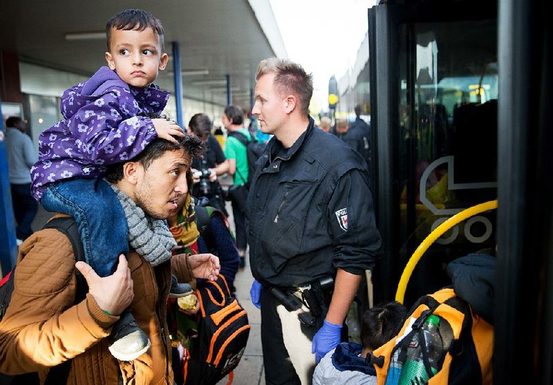 A migrant family arrives Sunday from southern Germany at a train station near Berlin. German officials said Sunday that the nation was reaching its capacity for refugees. 