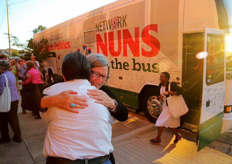 Martha Borders of Little Rock (left) hugs Sister Simone Campbell on Sunday evening at First United Methodist Church in Little Rock. Campbell and the other members of Network, a Catholic social-justice lobby, are on a 13-day, seven-state bus tour.