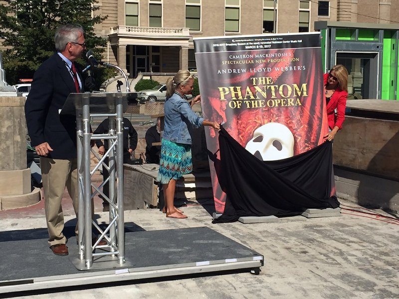 Ed Payton, CEO of Celebrity Attractions, looks on Monday, Sept. 14, 2015, as Melissa Lattin and Deana McCormack with Celebrity Attractions unveil a poster for "The Phantom of the Opera" at the Robinson Center in Little Rock. 