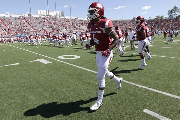 Arkansas wide receiver Keon Hatcher (4) warms up before an NCAA college football game between Arkansas and Toledo in Little Rock, Ark., Saturday, Sept. 12, 2015. (AP Photo/Danny Johnston)