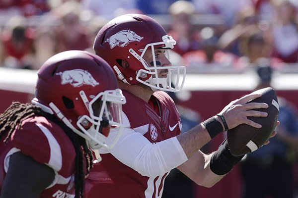 Arkansas quarterback Brandon Allen, right, takes a snap in the first half of an NCAA college football game against Toledo in Little Rock, Ark., Saturday, Sept. 12, 2015. (AP Photo/Danny Johnston)