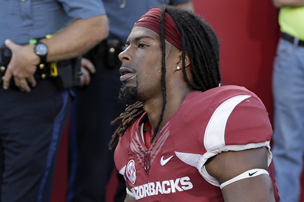 Arkansas wide receiver Keon Hatcher kneels on the sideline after an NCAA college football game in Little Rock, Ark., Saturday, Sept. 12, 2015. Toledo defeated Arkansas 16-12. (AP Photo/Danny Johnston)