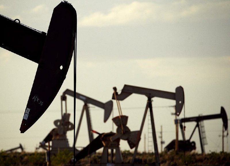 Pumpjacks work in an oil field near Lovington, N.M., in this file photo. A slump in prices will continue to weigh on U.S. shale-oil production, a report from OPEC said Monday. 