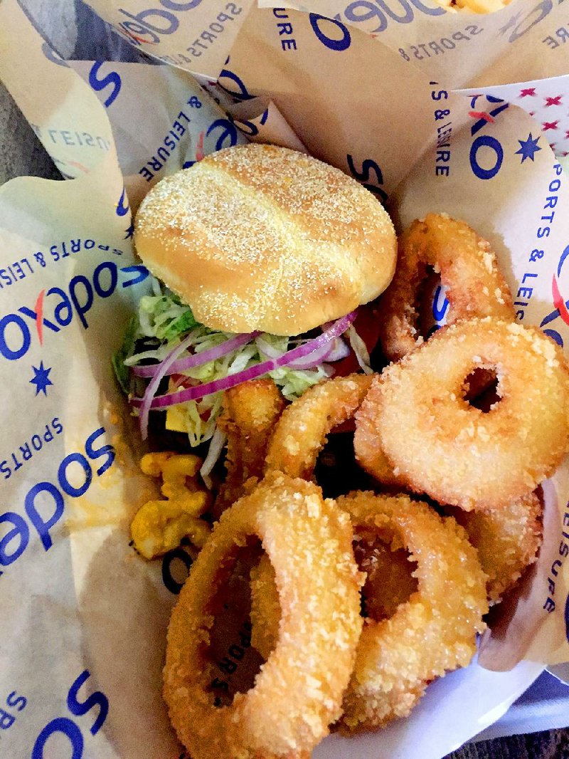 The Mac Attack Burger, sold at Donald W. Reynolds Razorback Stadium, is a cheeseburger with a scoop of macaroni and cheese on top — or spilling out. 