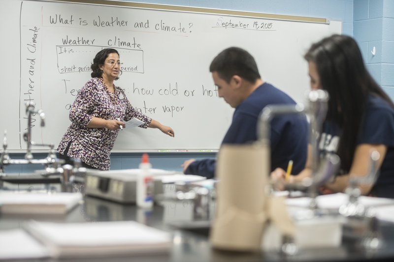 Ixchel Reyes teaches physical science in the language academy Monday at Har-Ber High School in Springdale. The high school has seen a rising student population with numbers exceeding 2,100 students. Reyes teaches her class in a science lab instead of a standard classroom to accommodate the higher number of students versus classrooms available. For more photos, go to www.nwadg.com/photos.