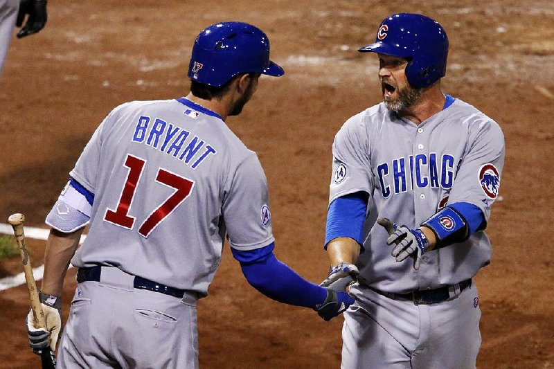 Chicago’s David Ross (right) celebrates with Kris Bryant after scoring on a double by Dexter Fowler in the fifth inning of the Cubs’ 2-1 victory over the Pittsburgh Pirates in the second game of Tuesday’s doubleheader in Pittsburgh.