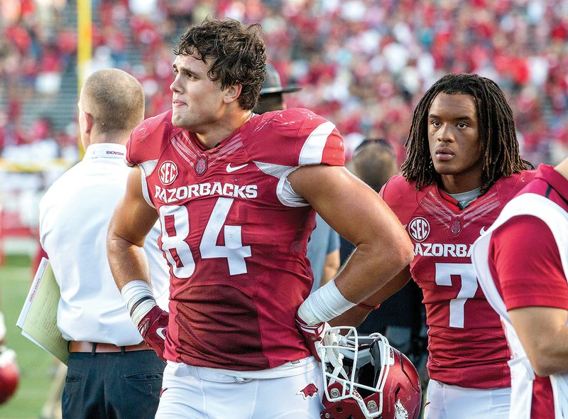 University of Arkansas junior tight end Hunter Henry (left) and sophomore wide receiver Damon Mitchell leave the field Sept. 12 following the Razorbacks’ 16-12 loss to the University of Toledo at War Memorial Stadium in Little Rock.