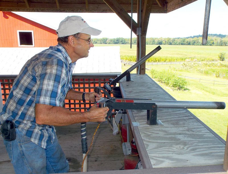 Photo by Randy Moll Taking aim at a large target downrange, Galen Manning, owner and manager of the Right Choices Corn Maze near Southwest City, Mo., fires an air-powered corn cannon on Thursday (Sept. 10, 2015).