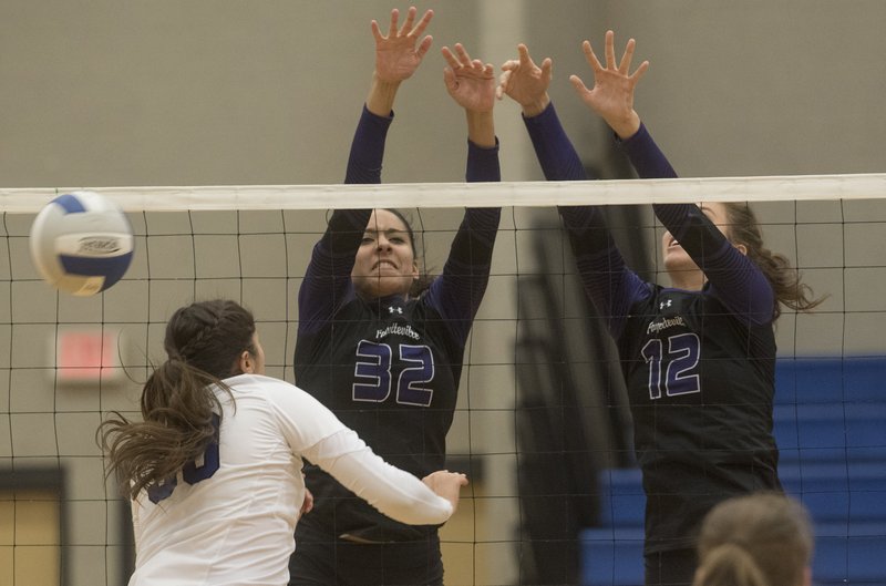 Rogers High’s Audrey Herrera gets her kill blocked Tuesday by Fayetteville’s Haley Warner (32) and Faith Waitsman in Rogers. Fayetteville swept the match, winning three games in a row. For a gallery of game photos, go to nwamedia.photoshelter.com.