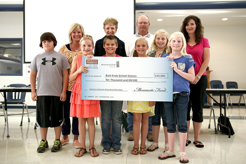 Gerald Reeves, local Monsanto representative, presented faculty and students of Bald Knob School District with a $10,000 grant Aug. 31. The grant was sponsored by the Monsanto fund through the America’s Farmers Grow Rural Education program and will help the school to purchase the Engineering in Elementary curriculum.  First row, from left, are Landon Monday, fifth grade, Addalie Haynes, fourth grade, Aaron King, fifth grade, Addington Strickland, fourth grade, Hailey Sterling, fifth grade, Hannah Sterling, fifth grade; and second row, Davissa Brimer, fourth-grade teacher, Pam Carpenter, fifth-grade teacher, Gerald Reeves, Monsanto representative, Kari Smith, fourth-grade teacher.